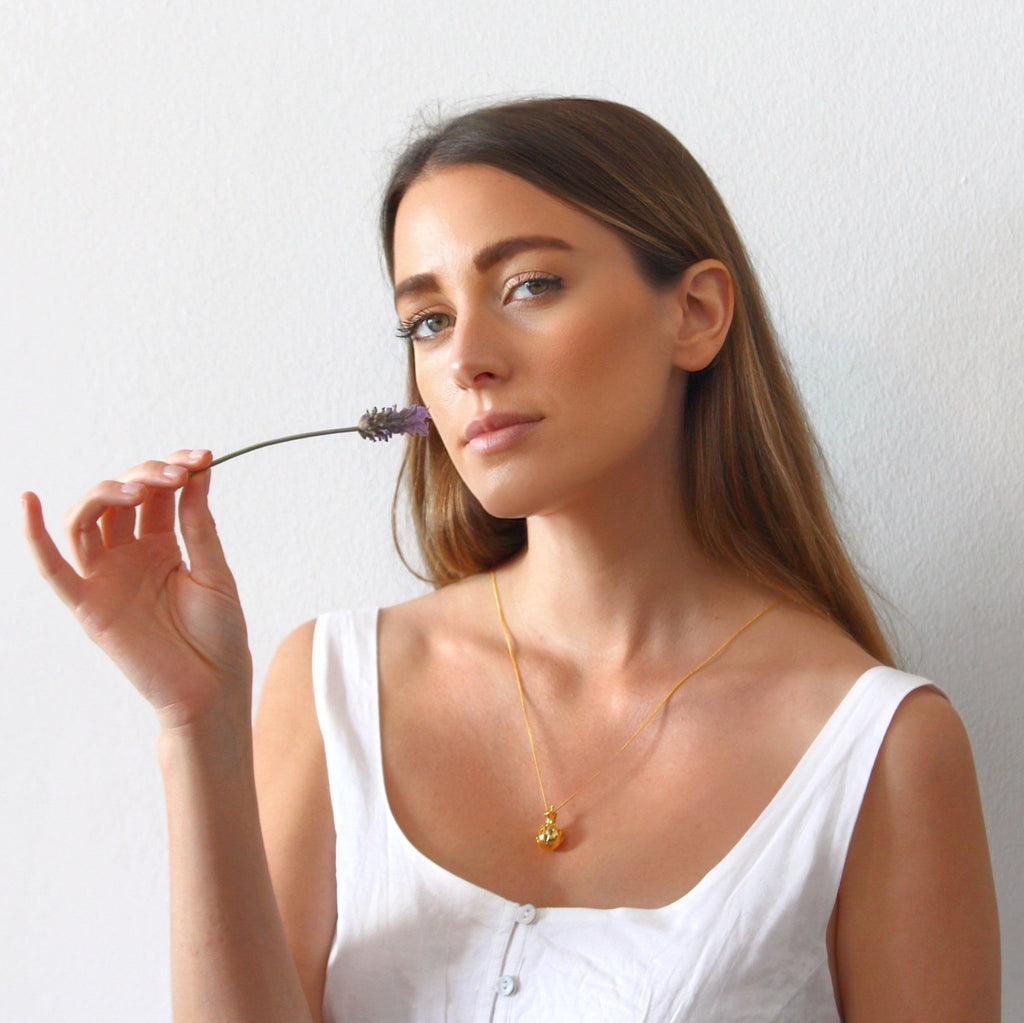 model wearing 18ct gold scented jewellery with lavender